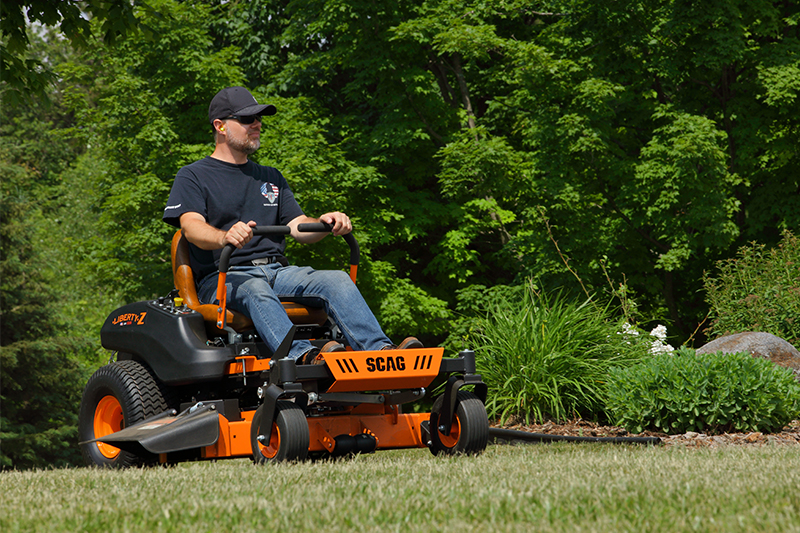 A man operating a Scag Liberty Z in a front yard.